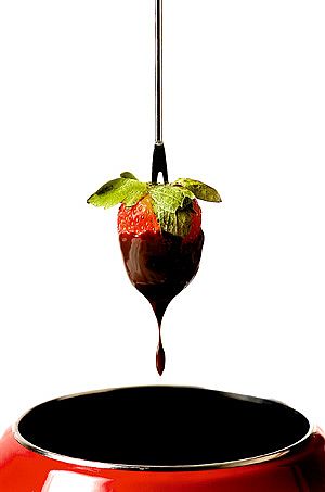 Strawberry dipped in amaretto chocolate fondue